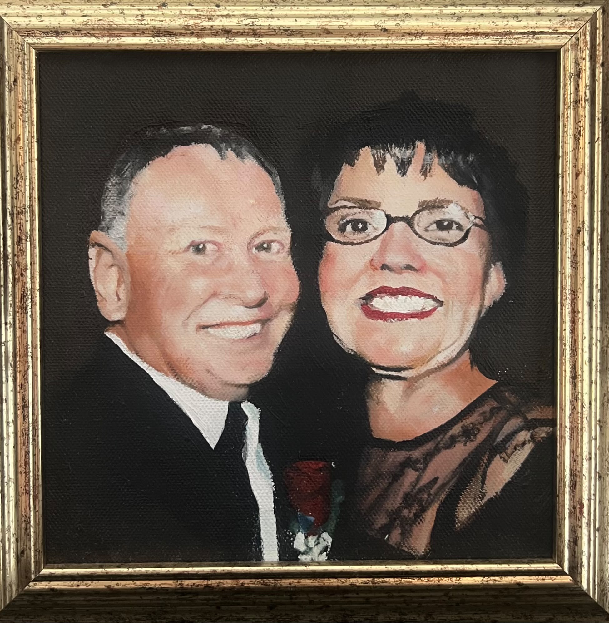 Oil portrait of a couple in a gold frame